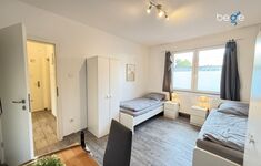 Schlafzimmer 1 mit zwei Einzelbetten, Sitzecke und Smart TV Schlafzimmer 1 mit zwei Einzelbetten, Sitzecke und Smart TV