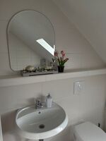 Badezimmer mit Waschmaschine und Badewanne Badezimmer mit Waschmaschine und Badewanne