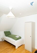 Schlafzimmer 2 mit zwei Einzelbetten, Sitzecke und Smart TV