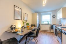 Küch mit großem Esstisch, 2 Kühlschränken, Mikrowelle, Spülmaschine, Backofen mit Herd und Waschtrockner-Kombigerät