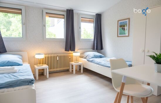 Schlafzimmer 1 mit zwei Einzelbetten, Sitzecke und Smart TV