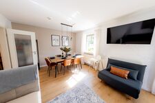 Wohnzimmer mit Esstisch und TV