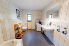 Badezimmer mit Toilette Waschbecken Waschmaschine