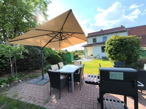 Garden with garden furniture, sun loungers, barbecue and children's play area