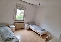 Schlafzimmer mit Tisch, Stühlen und Kleiderschrank