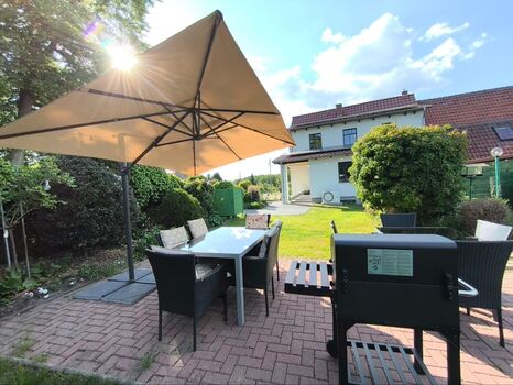 Communal garden for all guests of the house with seating, parasols, sun loungers and barbecue.