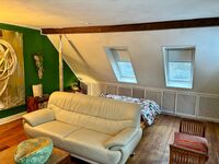 1. Schlafzimmer mit Doppelbett, Sofa, Sessel, Tisch, Sekretär und Fernseher