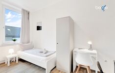 Schlafzimmer 2 mit zwei Einzelbetten, Sitzecke und Smart TV 