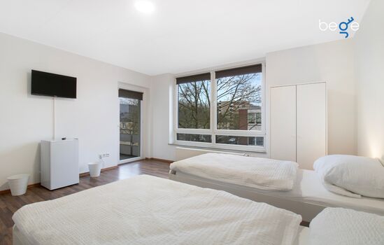 Schlafzimmer 1 mit zwei Einzelbetten, Sitzecke und Smart TV