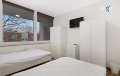 Schlafzimmer 3 mit zwei Einzelbetten, Sitzecke und Smart TV