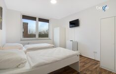 Schlafzimmer 2 mit zwei Einzelbetten, Sitzecke und Smart TV